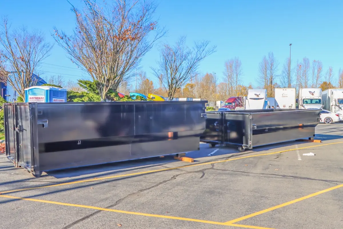 Professional dumpster rental service with roll-off container on residential driveway in Landen